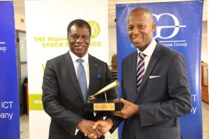Mr. Austin Okere, Chief Executive Officer, Computer Warehouse Group (CWG) Plc receiving the closing gong award from Mr. Ade Bajomo, Executive Director, Market Operations and Technology, The Nigerian Stock Exchange (NSE) at the Closing Gong Ceremony at the Nigerian Stock Exchange .